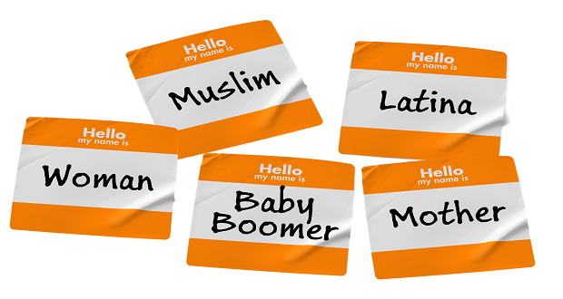 name tags showing different identity labels; Muslim, Latina, Baby boomer, Woman, Mother.